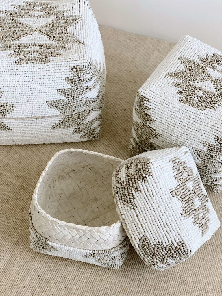 detailed shot of beaded bamboo nesting baskets in white and tan tribal print