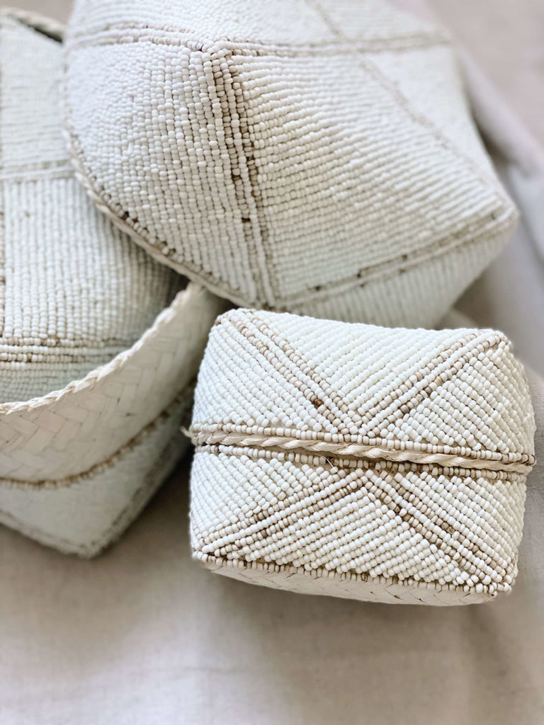 detailed shot of beaded bamboo baskets in white and tan minimalist design