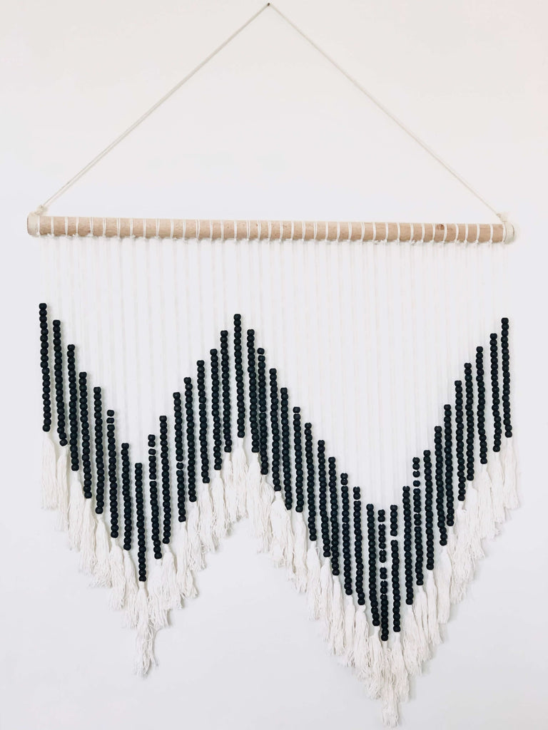 large bohemian handmade macrame wall hanging with black wooden beads and white tassels