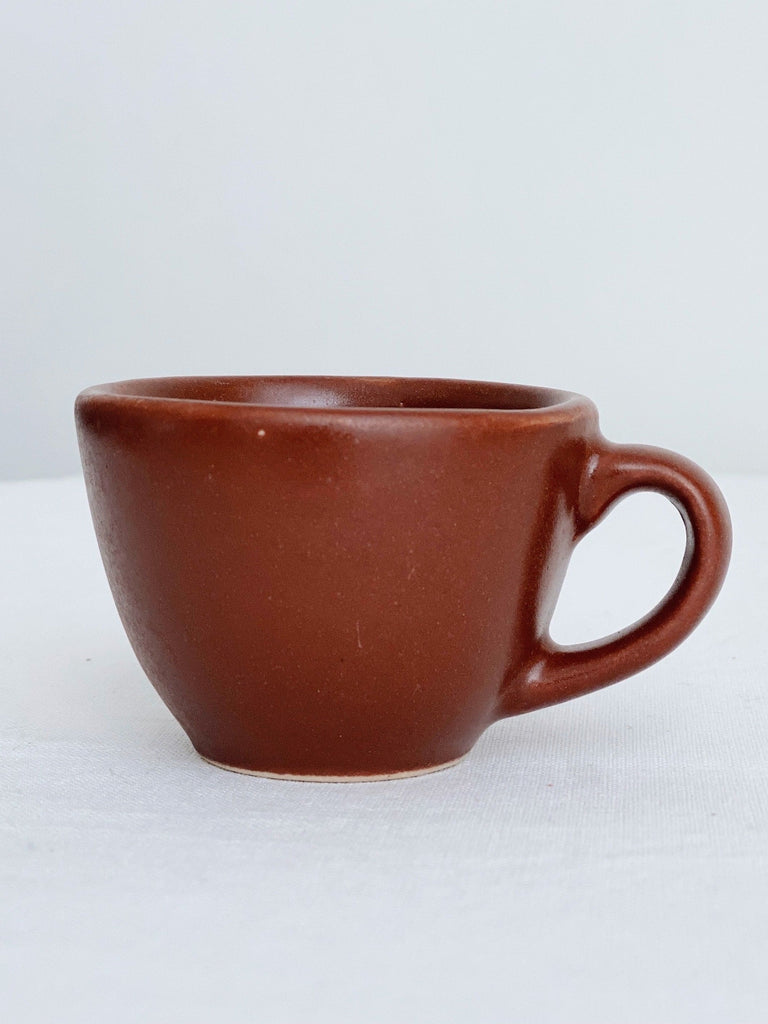 handmade red high fire clay stoneware espresso mug with white background