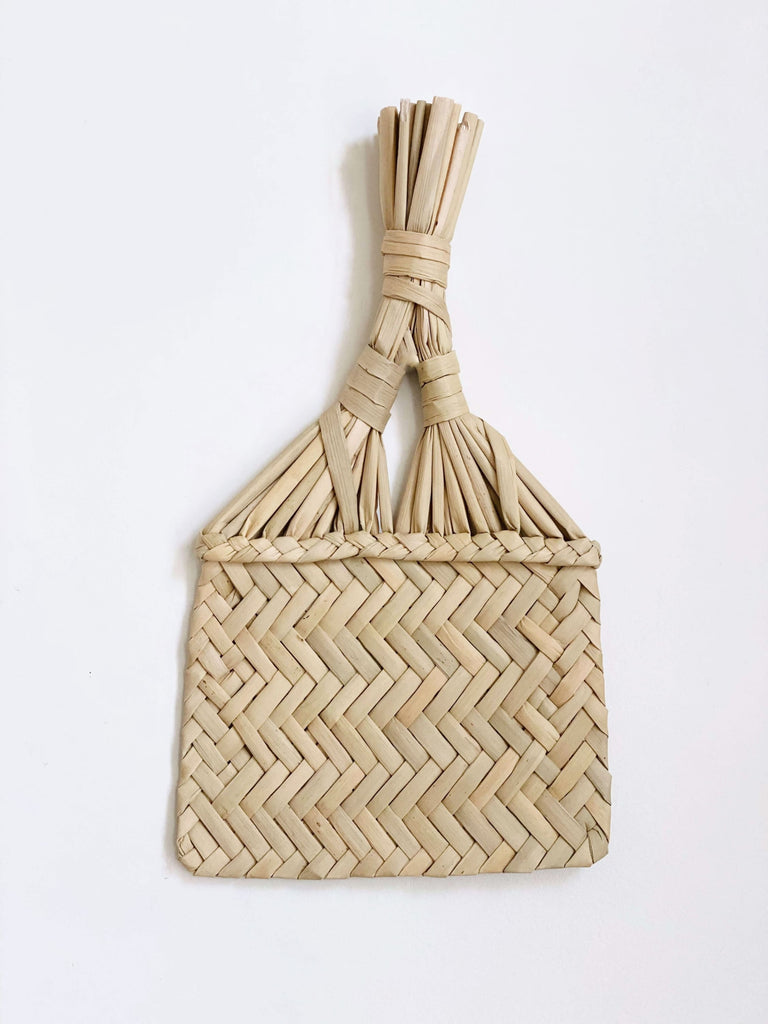 handmade small fan hanging on white wall