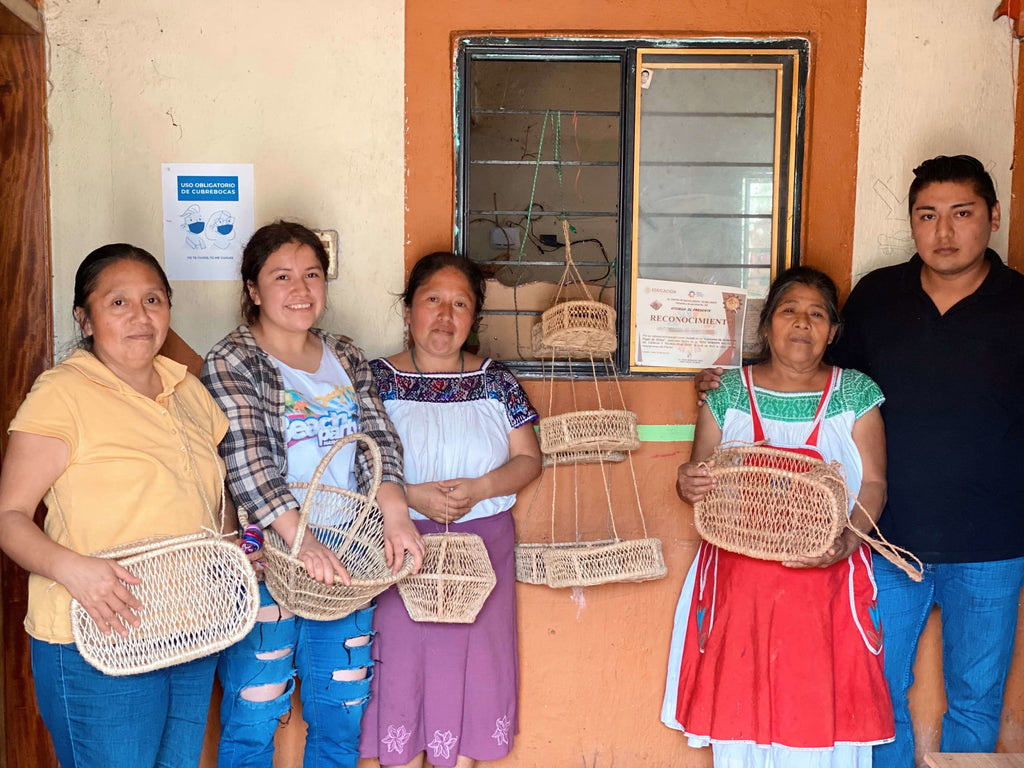 indonesian artisans posing with their handwoven beautiful jonote baskets