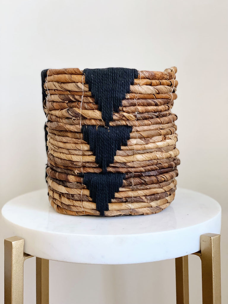 mini brown handwoven banana leaf plant basket pot with black triangle design on white stool