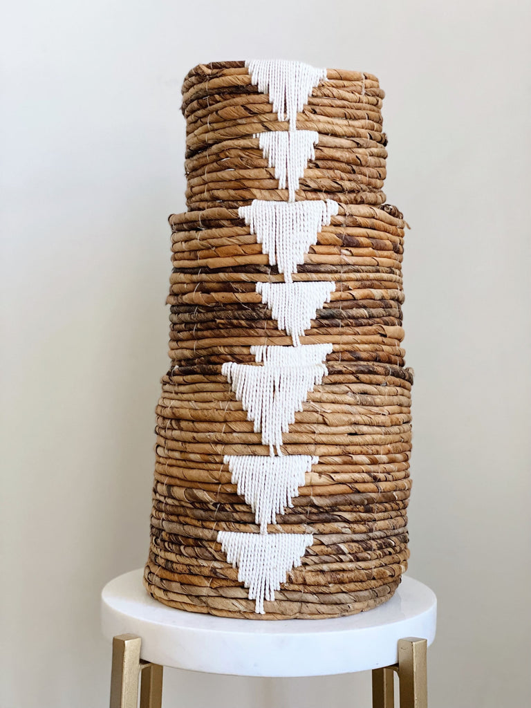 stacked trio of medium, small, and mini handwoven banana leaf plant basket on white stool