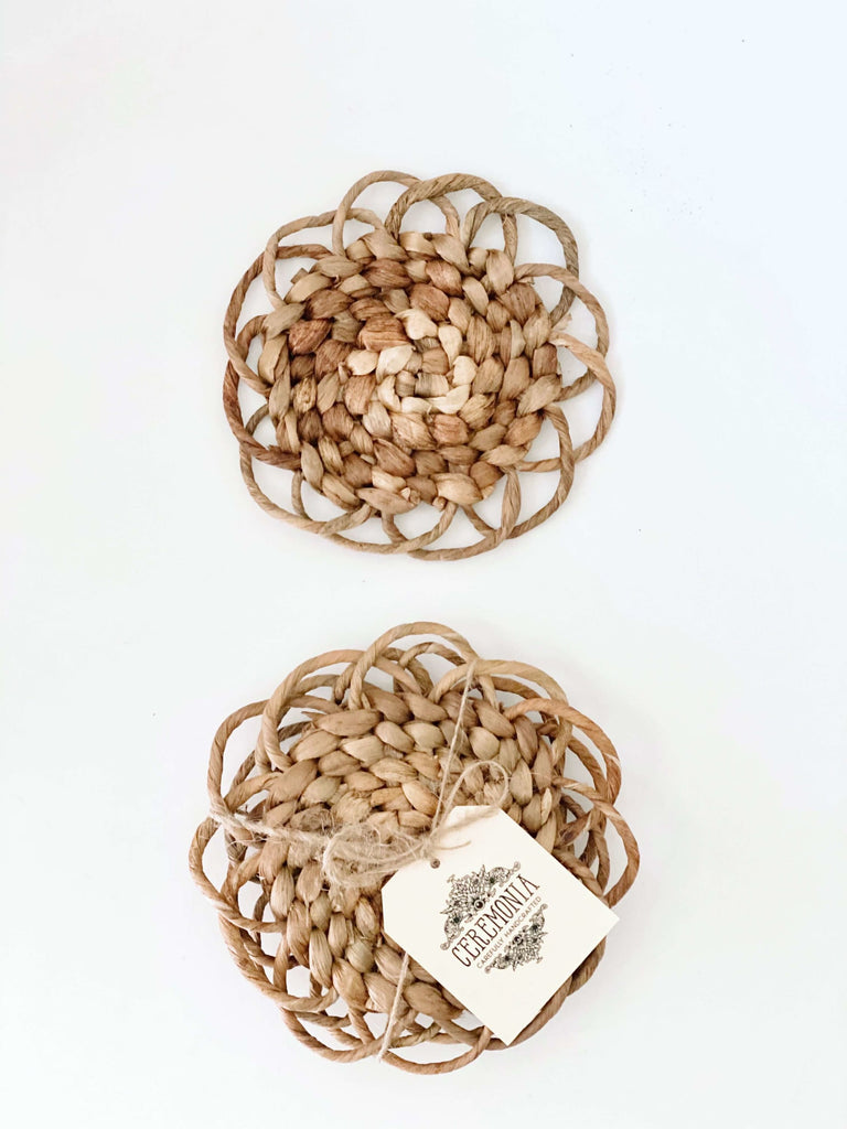 set of two handmade hyacinth flower coasters on white surface