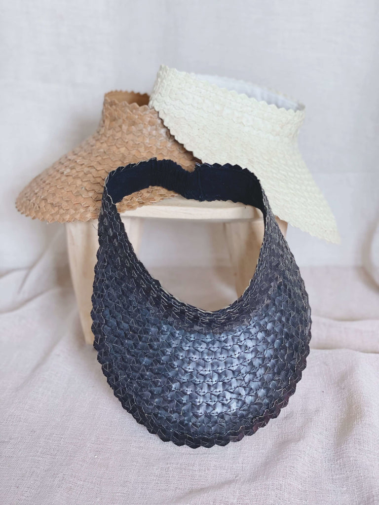 stack of three stunning bohemian handwoven palm leaf brown, black, and white sun visors