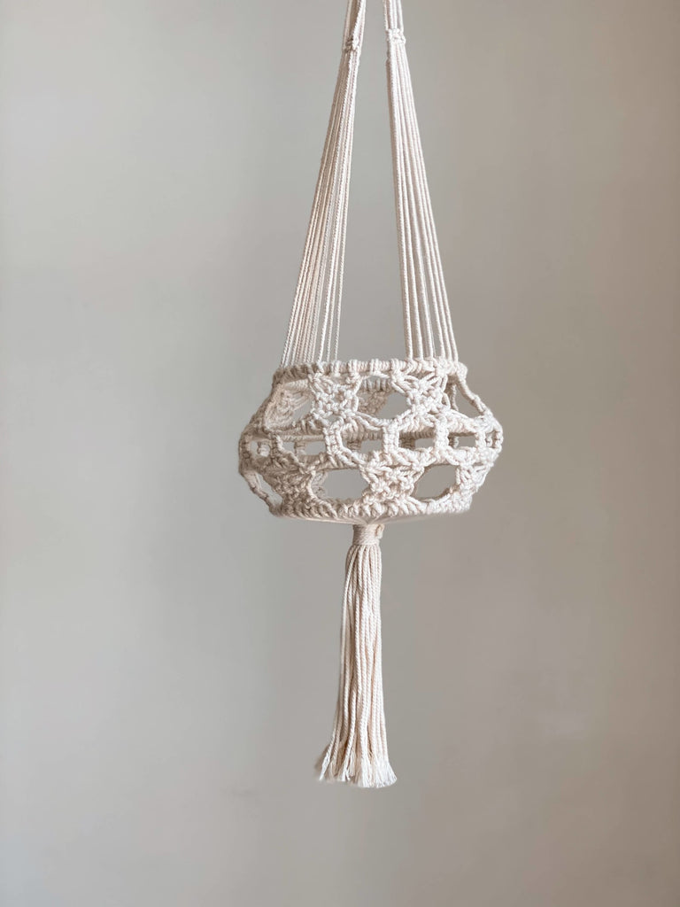 product photo of unique bohemian medium macrame plant hanger in white room
