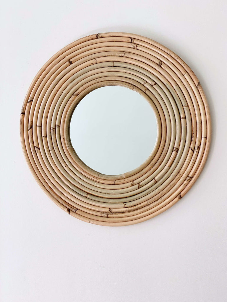 handmade rattan ring mirror on white wall