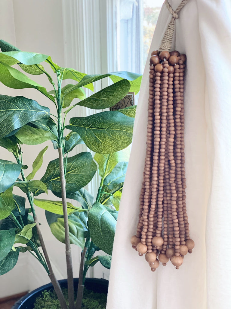 handmade brown wooden bead jute tie back tassel used as curtain tie back next to fiddle leaf fig