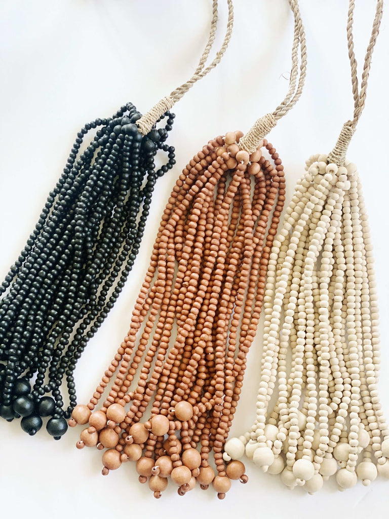 three boho bead tie-back tassels in black, brown, and natural colors displayed on white background
