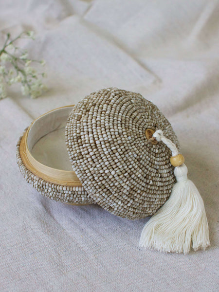 mini round hand-beaded tan bamboo basket with cream tassel 