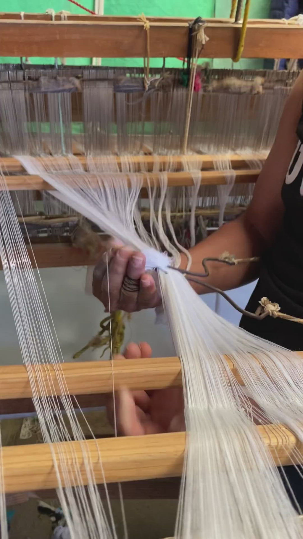 video of artisan partner hand-threading cotton to make CEREMONIA linen napkins