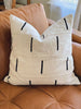 white dash vintage african mudcloth decorative pillow on brown leather sofa