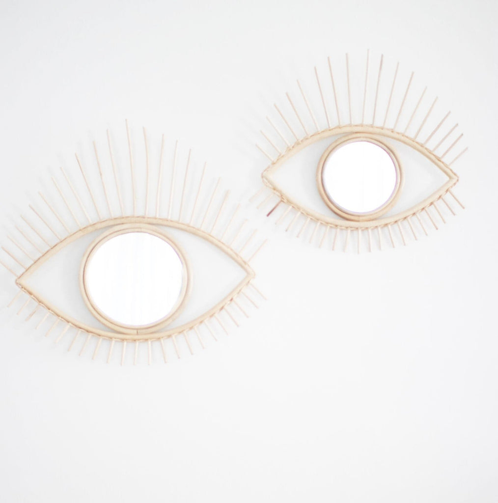 set of boho all seeing rattan eye mirror on a white wall