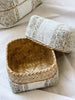 close up of inside of beaded bamboo basket in tan and white color