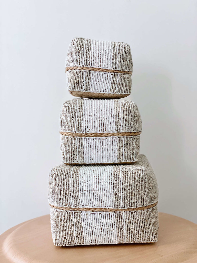 stack of 3 nesting handwoven beaded bamboo baskets in tan and white color