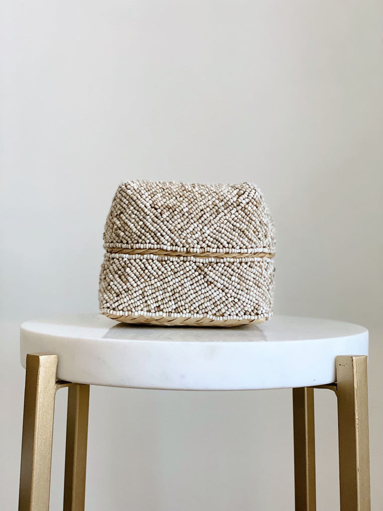 mini hand-beaded cream bamboo basket on white marble stool