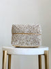 small hand-beaded cream bamboo basket on white marble stool