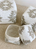 detailed shot of beaded bamboo nesting baskets in white and tan tribal print