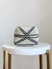mini hand-beaded tan and black stripe bamboo basket on white marble stool