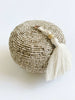 mini round hand-beaded natural bamboo basket with cream tassel on white background