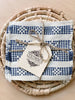 set of 4 waistloom embroidered coasters in blue colorway wrapped in twine