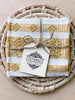 set of 4 waistloom embroidered coasters in yellow colorway wrapped in twine