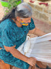 Indigenous artisan woman using waistloom to weave CEREMONIA embroidered throw pillow covers