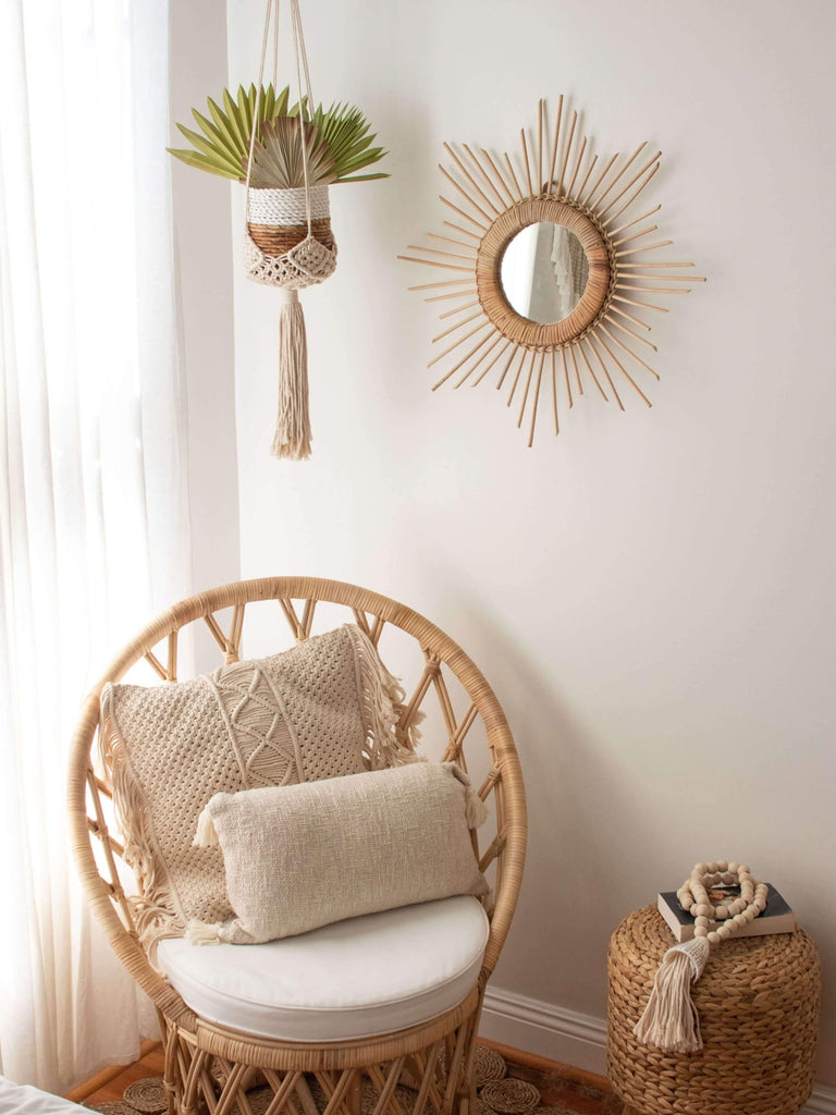 hanging macrame plant hanger next to wicker chair in bohemian bedroom corner with other boho decor