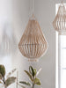 closeup of natural wooden bead chandeliers hanging over plants in a light filled room