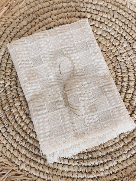 natural handwoven square linen napkin set with beautiful detail on raffia fringe coaster