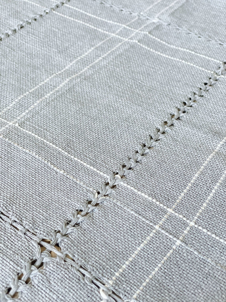 closeup detail of blue handwoven linen napkin with white stripes