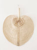 product photo of large natural bohemian handwoven palm leaf fan hanging on white wall