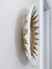 closeup of detail on the side of banana leaf seagrass handwoven cream wall basket hanging on white wall