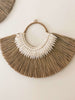 product shot of earthy bohemian mendong grass beaded wall hanging on white wall