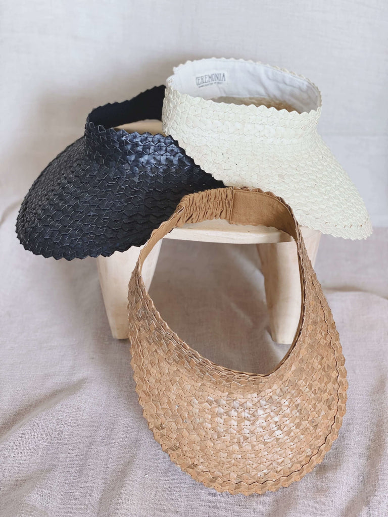 stack of three stunning bohemian handwoven palm leaf brown, black, and white sun visors