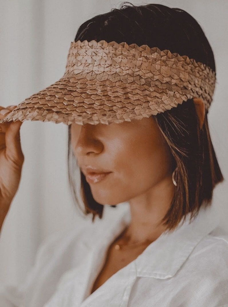 beautiful woman wearing stylish bohemian brown sun palm leaf visor