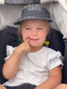 cute happy baby girl toddler wearing bohemian black palm leaf sun visor kid size hat