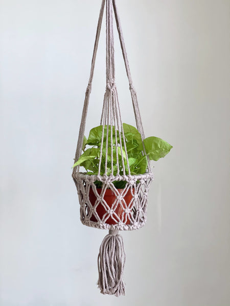 medium brown macrame handmade plant hanger basket with lush green plant