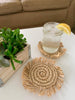 beautiful bohemian handwoven fringe coasters with a cup of lemon water next to succulents in a boho chic living room