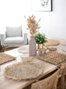 earth inspired bohemian dining room with natural handwoven straw placemats and gorgeous pampas and plants centerpieces