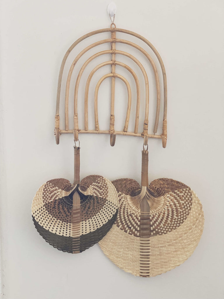 wooden five hook rainbow rack holding handwoven intricate palm leaf fans