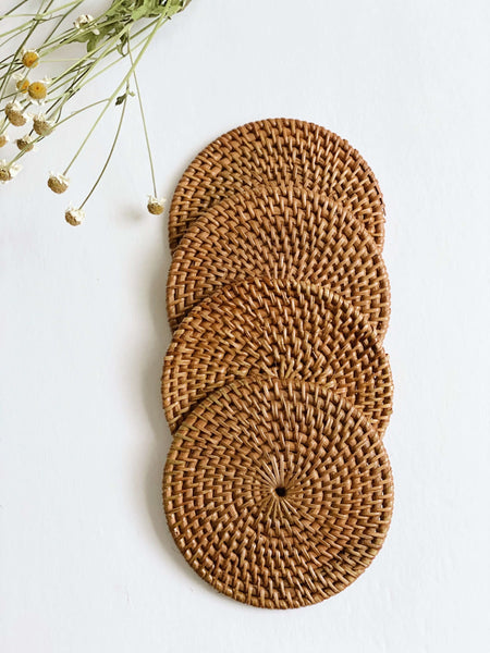 set of four handmade rattan coasters next to dainty florals