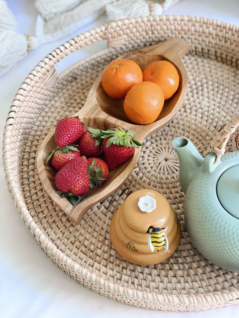 aesthetic summertime breakfast in bed with delicious fruit and tea on a handwoven rattan nesting tray