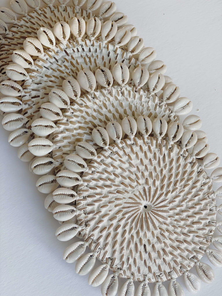 set of 4 rattan shell beverage coasters that have been handpainted a whitewash finish