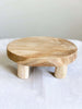 product photo of small handmade natural wooden riser on top of white tablecloth