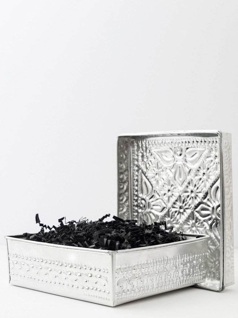 product photo of traditional balinese ceremony offering tin box with black paper confetti
