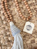 bohemian handcarved brown wooden bead conus shell tassel with white tassel on hyacinth placemat