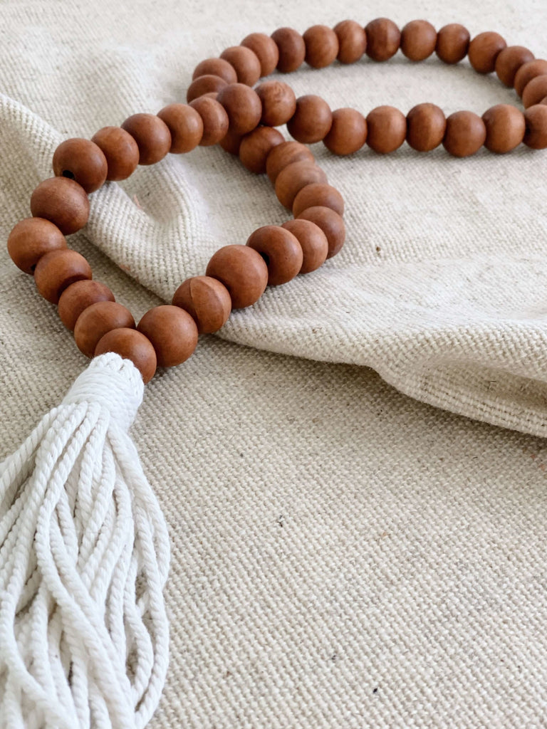handcarved wooden brown farmhouse beads on tan canvas