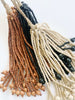 three boho bead tie-back tassels in black, brown, and natural colors displayed on white background